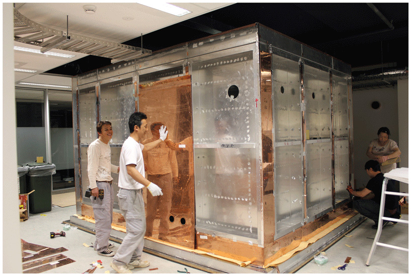 Figure 2 - Engineers building the magnetically shielded MEG room in our lab.