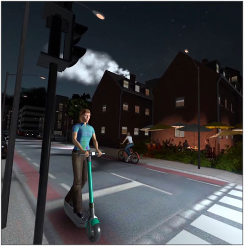 A person rides an electric scooter on a city street at night, passing by a cyclist. Nearby, people sit under umbrellas at an outdoor cafe. The scene is lit by streetlights, with a building in the background.