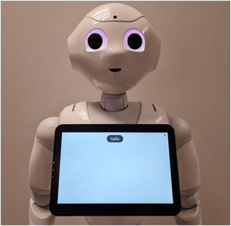 A humanoid robot with large eyes holds a tablet displaying the word