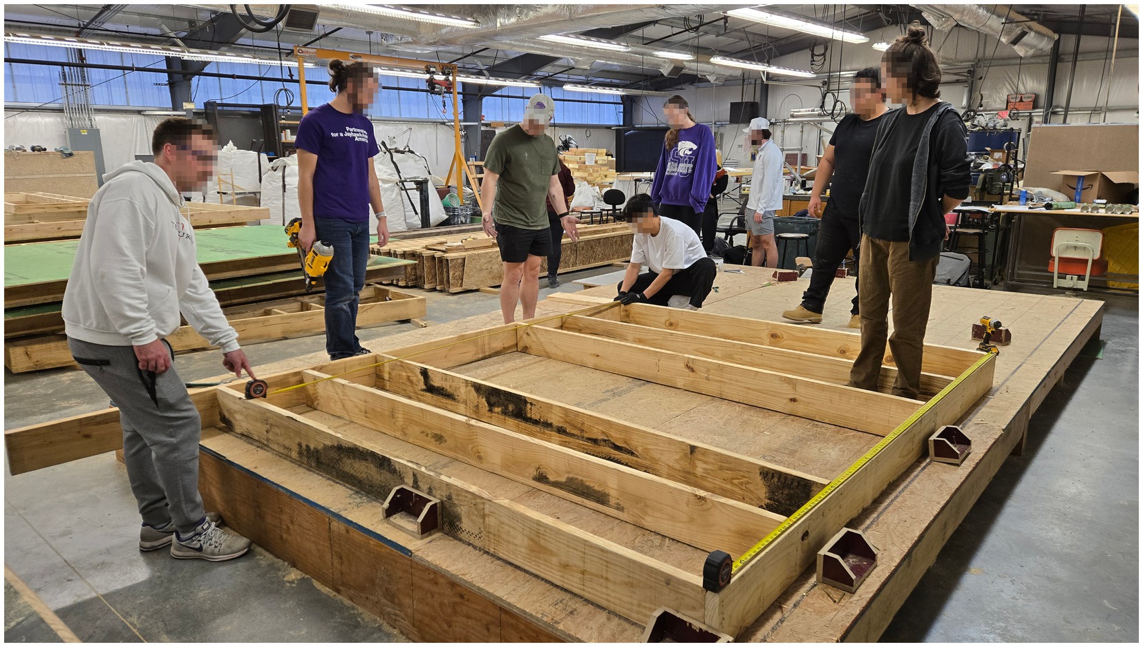 Architecture students in the author's studio assemble prefab panels for the ZCMH structure.