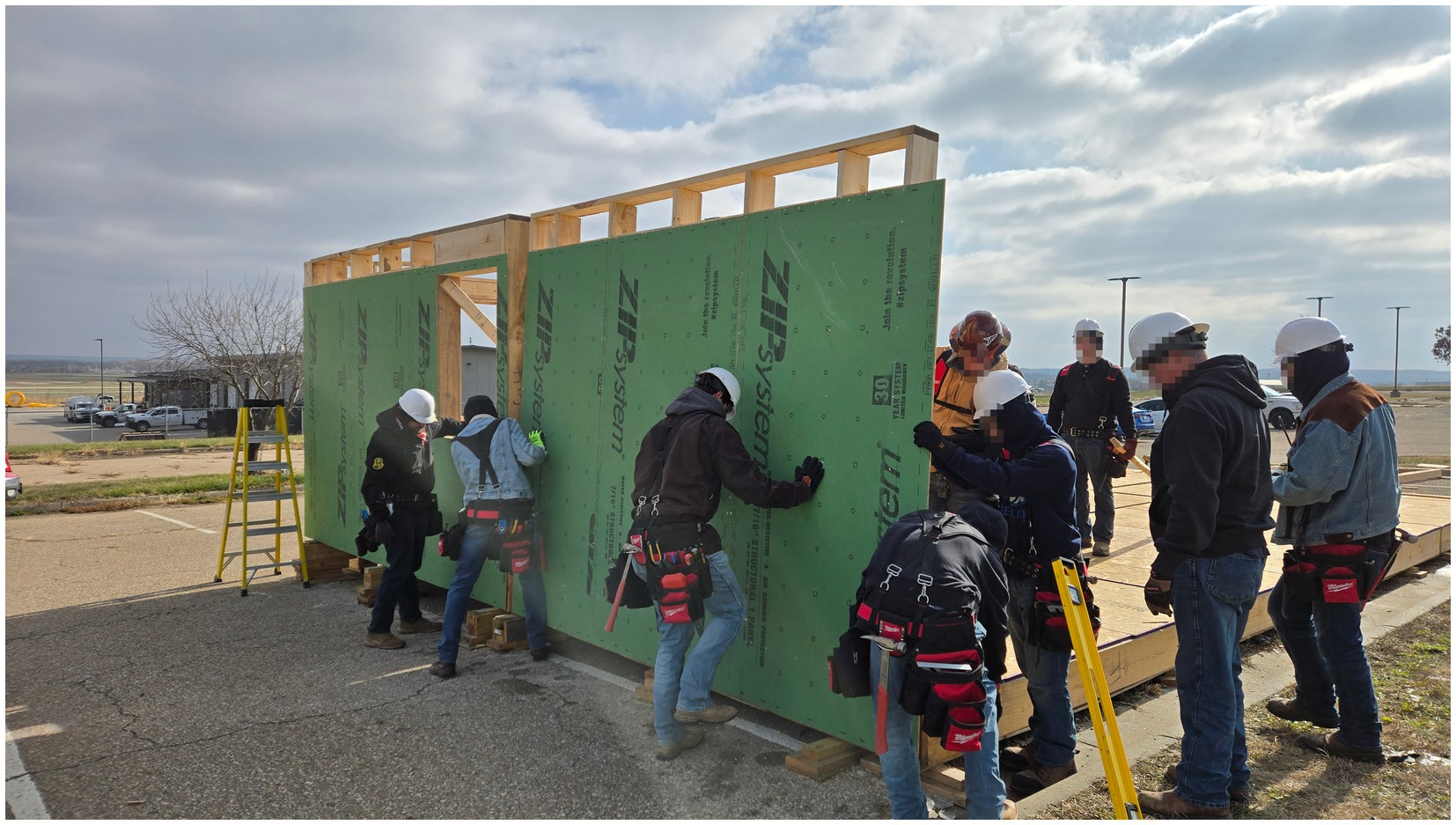 Technical college students erect prefab components to enclose the ZCMH.