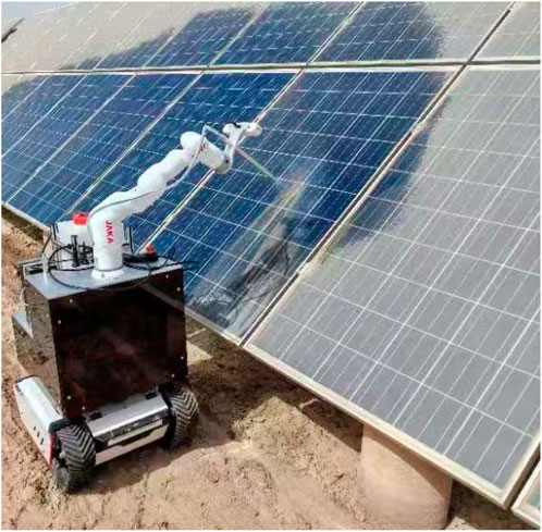 A robotic arm mounted on a wheeled platform positioned next to large solar panels. The robot appears to be designed for maintenance or cleaning tasks, operating in a sunny outdoor setting.