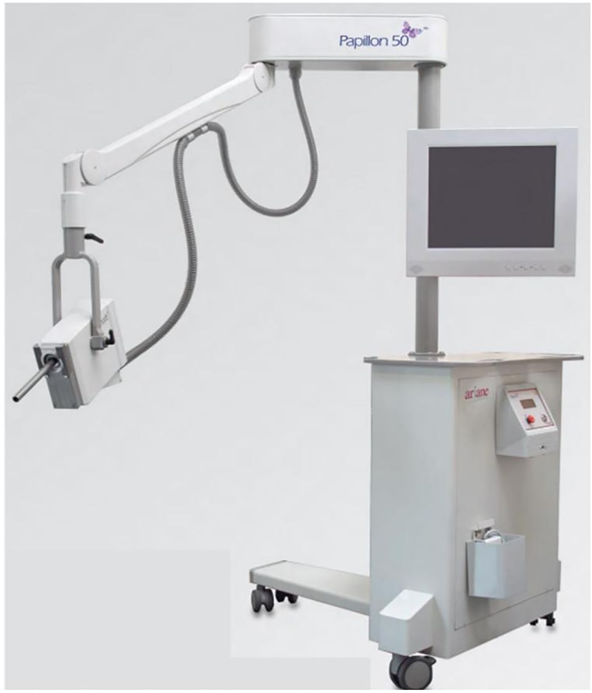 Medical equipment labeled “Papillon 50” with an adjustable arm, a box-like device, and a monitor mounted on a wheeled base. The control unit features buttons and a display screen.