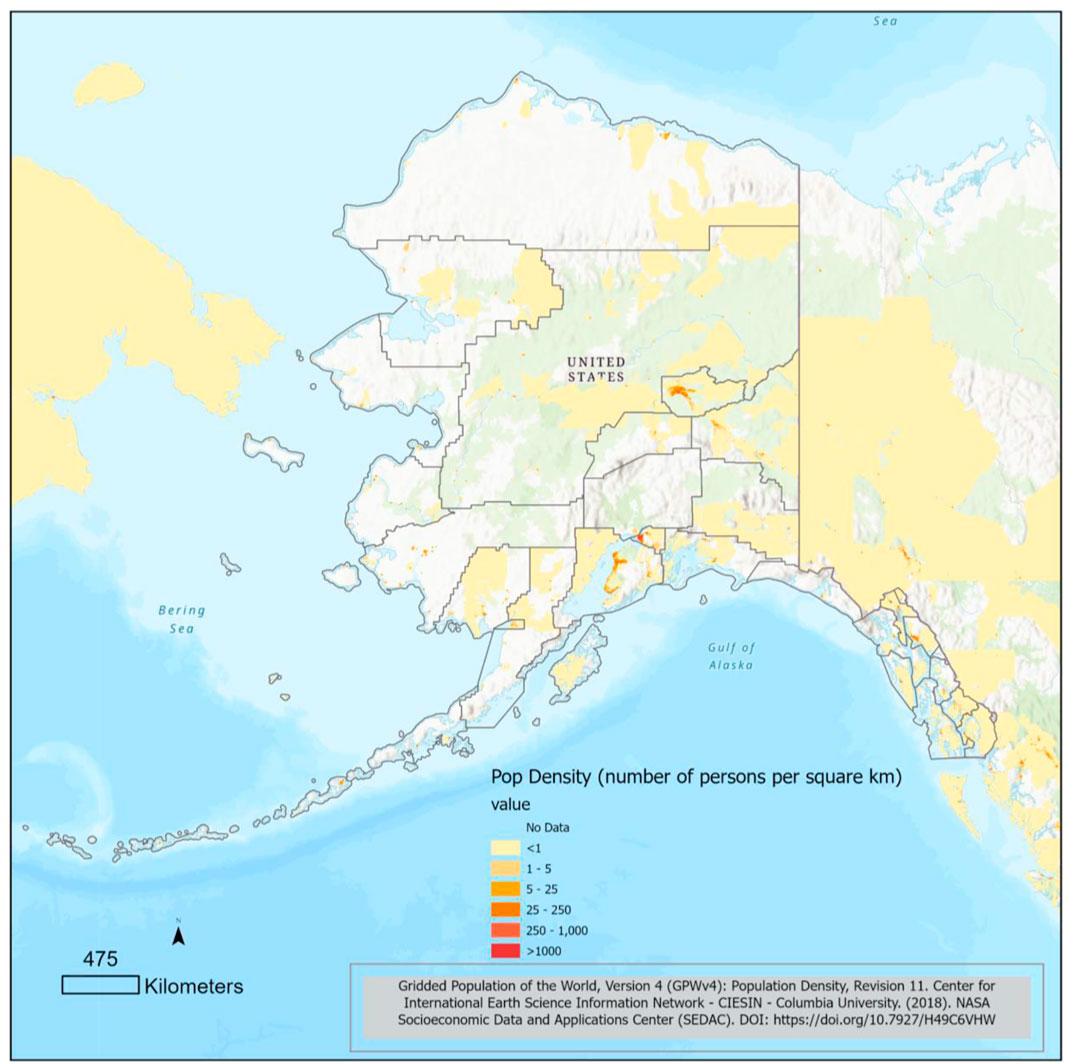 Map of Alaska displaying population density measured in persons per square kilometer. Areas are color-coded: light yellow for fewer than one, orange for one to five, and red for more than 250. Most of Alaska is sparsely populated. A scale of four hundred seventy-five kilometers and a compass point are included.