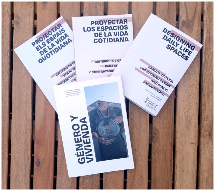 Four books are arranged on a wooden surface. The titles are
