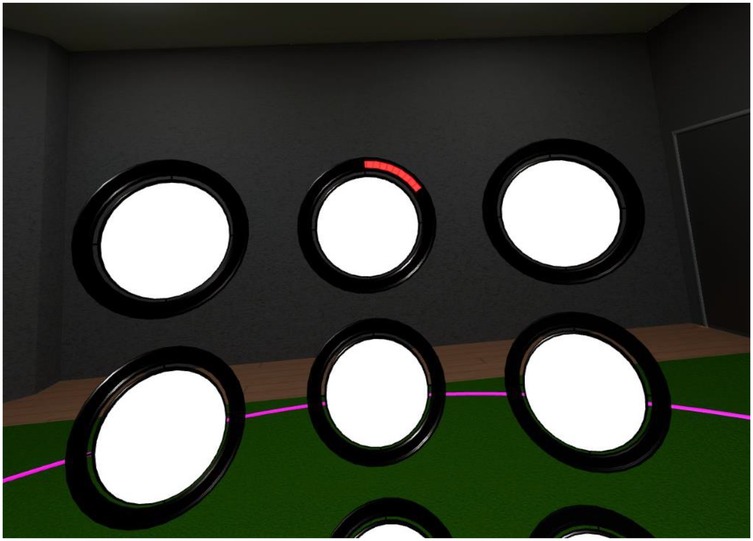 A virtual reality interface displays seven circular discs on a dark background, arranged in a grid. One disc in the top row has a red progress indicator at the top edge. The floor appears green with a pink circle partially visible.