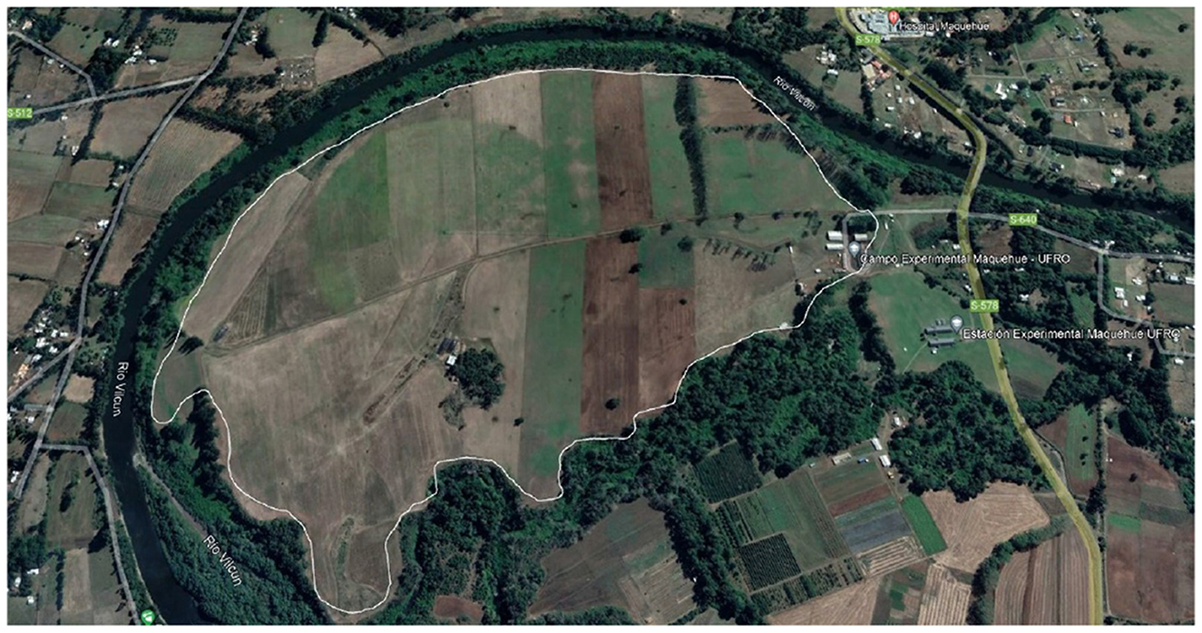 Aerial view of fields and farmland bordered by the Rio Vilcun. The land is segmented into various rectangular plots with different shades of brown and green. Roads and small buildings are visible on the eastern side. Labeled as UFRO Experimental Station.