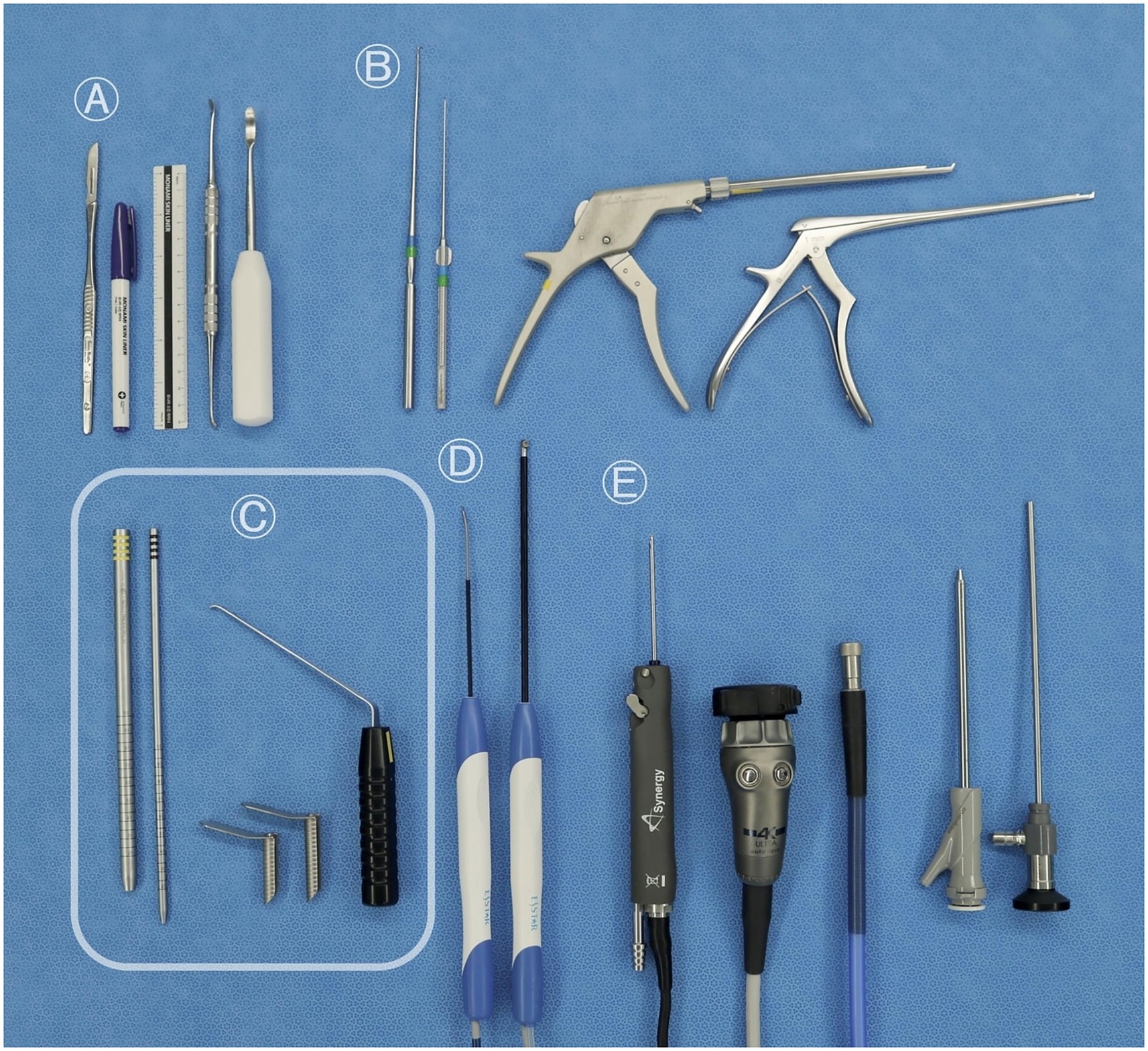 Surgical instruments are arranged on a blue background, labeled A to E. A includes scalpels and a marker. B shows slender metal probes. C displays metal rods with hooks and screws. D has instruments with blue and white handles. E features a camera-like device with cables and metal rods.