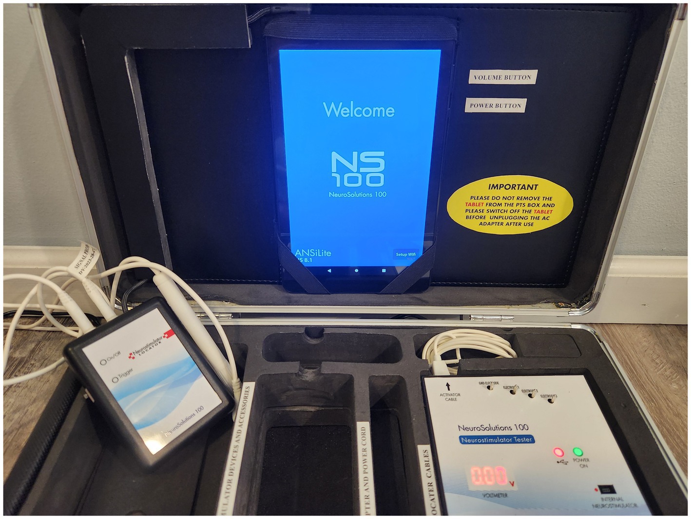 A portable neurophysiology equipment case containing various components, including a control unit labeled