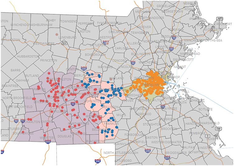 Map of parts of Massachusetts featuring clusters of colored dots: red, blue, and orange. Red and blue dots are concentrated in the western region while orange dots are in the eastern section, near Boston. Political boundaries and major highways are outlined.