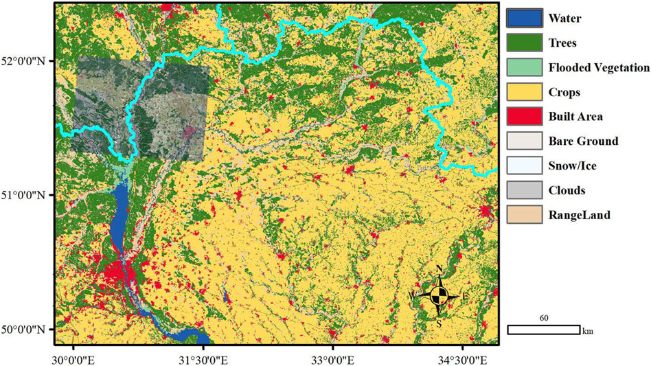 Map illustrating land cover with a color-coded key. Blue represents water bodies, green for trees, light green for flooded vegetation, yellow for crops, red for built areas, grey for bare ground, light grey for snow or ice, darker grey for clouds, and tan for rangeland. A river runs through the center, surrounded by various land types. A compass rose and scale bar are included, along with latitude and longitude markers.