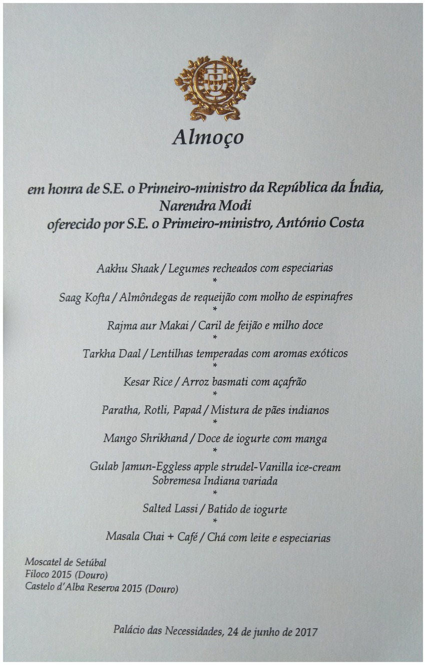 Menu card titled “Almoço” for a lunch in honor of India’s Prime Minister Narendra Modi, hosted by Prime Minister António Costa. It lists dishes including Aabhu Shauk, Saag Kofta, Rajma aur Makai, Tarkha Daal, Kesar Rice, Paratha, Roti, Papad, Mango Shrikhand, Gulab Jamun, eggless apple strudel, vanilla ice cream, and salted lassi. It also includes Masala Chai and coffee. Wines listed are Moscatel de Setúbal, Filoco 2015, and Castelo d’Alba Reserva 2015. The event is dated June 24, 2017, at Palácio das Necessidades.