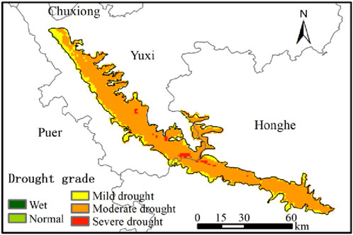 Map depicting drought grades in a region including Chuxiong, Yuxi, and Honghe. Colored areas indicate drought severity: green for wet, light green for normal, yellow for mild drought, orange for moderate drought, and red for severe drought. A scale bar indicates distances in kilometers.