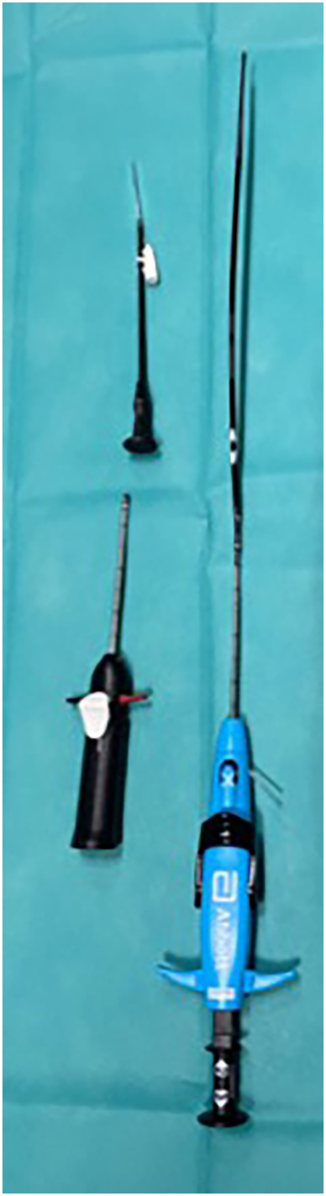 Surgical instruments arranged on a teal surface, including a long probe with a blue handle, a black device with attachments, and a slender, pointed tool.