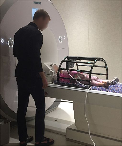 Figure 2 - A 4-year old child being put into a fMRI scanner to measure brain activity.
